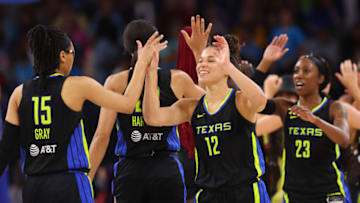 CHICAGO, ILLINOIS - AUGUST 02: Veronica Burton #12 of the Dallas Wings high fives teammates after defeating the Chicago Sky 84-78 at Wintrust Arena on August 02, 2022 in Chicago, Illinois. (Photo by Michael Reaves/Getty Images)