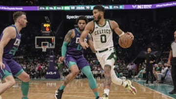 Oct 25, 2021; Charlotte, North Carolina, USA; Boston Celtics forward Jayson Tatum (0) on the dribble covered by Charlotte Hornets forward Miles Bridges (0) and forward Gordon Hayward (20) during overtime at the Spectrum Center. Mandatory Credit: Jim Dedmon-USA TODAY Sports