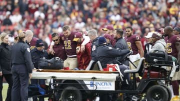 LANDOVER, MD - NOVEMBER 18: Alex Smith #11 of the Washington Redskins is helped off the field after being sacked and injured by Kareem Jackson #25 of the Houston Texans in the third quarter of the game at FedExField on November 18, 2018 in Landover, Maryland. (Photo by Joe Robbins/Getty Images)