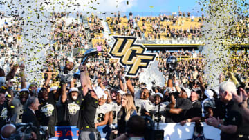ORLANDO, FL - DECEMBER 2: Head coach Scott Frost of the UCF Knights hoists the American Athletics Conference Trophy after winning the ACC Championship 62-55 against the Memphis Tigers at Spectrum Stadium on December 2, 2017 in Orlando, Florida. (Photo by Julio Aguilar/Getty Images)