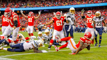 KANSAS CITY, MO - DECEMBER 29: Damien Williams #26 of the Kansas City Chiefs falls over the goal line for a fourth quarter 7-yard touchdown against the Los Angeles Chargers at Arrowhead Stadium on December 29, 2019 in Kansas City, Missouri. (Photo by David Eulitt/Getty Images)