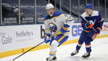 Mar 4, 2021; Uniondale, New York, USA; Buffalo Sabres center Jack Eichel (9) plays the puck against New York Islanders defenseman Ryan Pulock (6) during the first period at Nassau Veterans Memorial Coliseum. Mandatory Credit: Brad Penner-USA TODAY Sports