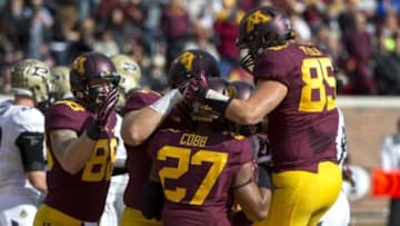 Oct 18, 2014; Minneapolis, MN, USA; Minnesota Golden Gophers running back David Cobb (27) gets congratulated after scoring a touchdown by tight end Maxx Williams (88), offensive lineman Josh Campion (65) and tight end Lincoln Plsek (85) in the first half against the Purdue Boilermakers at TCF Bank Stadium. Mandatory Credit: Jesse Johnson-USA TODAY Sports