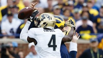 Sep 17, 2016; Ann Arbor, MI, USA; Colorado Buffaloes defensive back Chidobe Awuzie (4) rushes on Michigan Wolverines quarterback Wilton Speight (3) and causes a fumble in the first quarter at Michigan Stadium. Mandatory Credit: Rick Osentoski-USA TODAY Sports