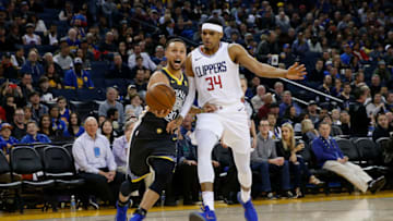OAKLAND, CA - FEBRUARY 22: Stephen Curry #30 of the Golden State Warriors is defended by Tobias Harris #34 of the Los Angeles Clippers at ORACLE Arena on February 22, 2018 in Oakland, California. NOTE TO USER: User expressly acknowledges and agrees that, by downloading and or using this photograph, User is consenting to the terms and conditions of the Getty Images License Agreement. (Photo by Lachlan Cunningham/Getty Images)