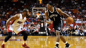 Mar 12, 2014; Miami, FL, USA; Brooklyn Nets guard Joe Johnson (7) dribbles against Miami Heat guard Dwyane Wade (3) during the first half at American Airlines Arena. Mandatory Credit: Steve Mitchell-USA TODAY Sports