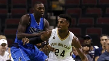 Oct 1, 2016; Bossier City, LA, USA; New Orleans Pelicans guard Buddy Hield (24) dribbles on Dallas Mavericks forward Dorian Finney-Smith (10) during the first half at CenturyLink Center. Mandatory Credit: Ray Carlin-USA TODAY Sports