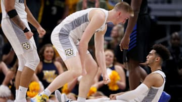 MILWAUKEE, WISCONSIN - DECEMBER 21: Sam Hauser #10 and Markus Howard #0 of the Marquette Golden Eagles react in the second half against the Buffalo Bulls at the Fiserv Forum on December 21, 2018 in Milwaukee, Wisconsin. (Photo by Dylan Buell/Getty Images)