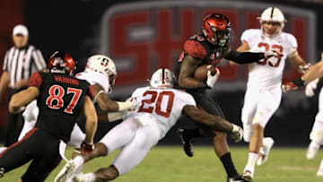 SAN DIEGO, CA - SEPTEMBER 16: Rashaad Penny #20 of the San Diego State Aztecs runs past Bobby Okereke #20 of the Stanford Cardinal during the first half of a game at Qualcomm Stadium on September 16, 2017 in San Diego, California. (Photo by Sean M. Haffey/Getty Images)