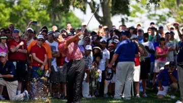 Mar 27, 2011; Orlando, FL, USA; Tiger Woods plays from under the trees on the ninth hole during the final round of the Arnold Palmer Invitational at Bay Hill Club