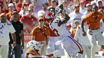 Oct 9, 2021; Dallas, Texas, USA; Oklahoma Sooners wide receiver Marvin Mims (17) makes a catch in front of Texas Longhorns defensive back B.J. Foster (25) during the second half at the Cotton Bowl. Mandatory Credit: Kevin Jairaj-USA TODAY Sports