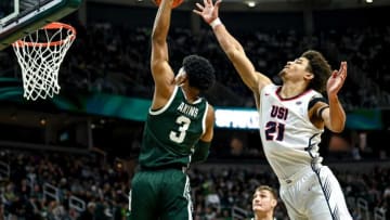 Michigan State's Jaden Akins, left, dunks as Southern Indiana's AJ Smith defends during the first half on Thursday, Nov. 9, 2023, at the Breslin Center in East Lansing.