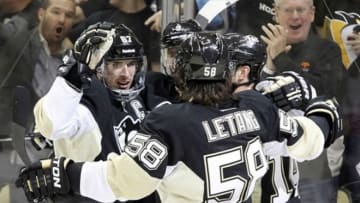 May 17, 2013; Pittsburgh, PA, USA; Pittsburgh Penguins center Sidney Crosby (87) celebrates with left wing Chris Kunitz (14) and defenseman Kris Letang (58) after Crosby scored his second goal against the Ottawa Senators during the first period in game two of the second round of the 2013 Stanley Cup Playoffs at CONSOL Energy Center. Mandatory Credit: Charles LeClaire-USA TODAY Sports