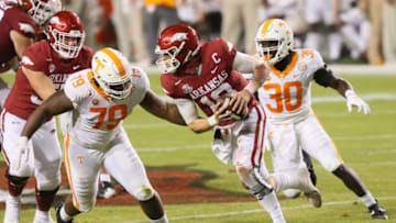 Nov 7, 2020; Fayetteville, Arkansas, USA; Arkansas Razorbacks quarterback Feleipe Franks (13) rushes in the second quarter as Tennessee Volunteers defensive lineman Kurott Garland (79) and linebacker Roman Harrison (30) defend at Donald W. Reynolds Razorback Stadium. Mandatory Credit: Nelson Chenault-USA TODAY Sports