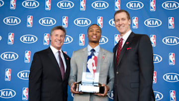 PORTLAND, OR - MAY 1: Damian Lillard #0 of the Portland Trail Blazers, center, Neil Olshey, the team's general manager, left, and head coach Terry Stotts pose with the Eddie Gottlieb Trophy after Lillard won the 2012-2013 Kia NBA Rookie of the Year award on May 1, 2013 at the Rose Garden Arena in Portland, Oregon. NOTE TO USER: User expressly acknowledges and agrees that, by downloading and or using this photograph, user is consenting to the terms and conditions of the Getty Images License Agreement. Mandatory Copyright Notice: Copyright 2013 NBAE (Photo by Sam Forencich/NBAE via Getty Images)