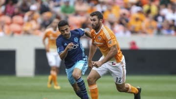 Apr 10, 2016; Houston, TX, USA; Houston Dynamo defender Will Bruin (12) attempts to advance the ball as Seattle Sounders midfielder Cristian Roldan (7) defends during the second half at BBVA Compass Stadium. The Dynamo and Sounders tied 1-1. Mandatory Credit: Troy Taormina-USA TODAY Sports