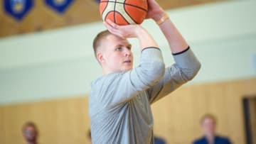 13 July 2018, Berlin, Germany: Kristaps Porzingis (R), power forward of the New York Knicks plays with youth players of the basketball team ALBA Berlin during a joint training session. The Latvian basketball player is currently on an advertising tour in Germany. Photo: Gregor Fischer/dpa (Photo by Gregor Fischer/picture alliance via Getty Images)