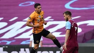 Wolverhampton Wanderers' Portuguese midfielder Pedro Neto (L) jumps as he celebrates scoring their second goal during the English Premier League football match between West Ham United and Wolverhampton Wanderers at The London Stadium, in east London on June 20, 2020. (Photo by Ben STANSALL / POOL / AFP) / RESTRICTED TO EDITORIAL USE. No use with unauthorized audio, video, data, fixture lists, club/league logos or 'live' services. Online in-match use limited to 120 images. An additional 40 images may be used in extra time. No video emulation. Social media in-match use limited to 120 images. An additional 40 images may be used in extra time. No use in betting publications, games or single club/league/player publications. / (Photo by BEN STANSALL/POOL/AFP via Getty Images)