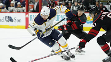 RALEIGH, NC - JANUARY 11: Carolina Hurricanes Defenceman Trevor van Riemsdyk (57) and Carolina Hurricanes Right Wing Saku Maenalanen (8) defends Buffalo Sabres Winger Evan Rodrigues (71) during a game between the Carolina Hurricanes and the Buffalo Sabres at the PNC Arena in Raleigh, NC on January 11, 2019. (Photo by Greg Thompson/Icon Sportswire via Getty Images)