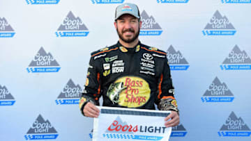 KANSAS CITY, KS - OCTOBER 20: Martin Truex Jr., driver of the #78 Bass Pro Shops/Tracker Boats Toyota, poses for a photo after winning the pole award during qualifying for the Monster Energy NASCAR Cup Series Hollywood Casino 400 at Kansas Speedway on October 20, 2017 in Kansas City, Kansas. (Photo by Jared C. Tilton/Getty Images)