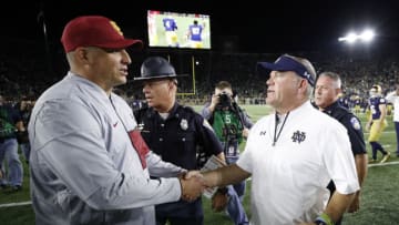 SOUTH BEND, IN - OCTOBER 21: Head coach Brian Kelly of the Notre Dame Fighting Irish shakes hands with head coach Clay Helton of the USC Trojans after a game at Notre Dame Stadium on October 21, 2017 in South Bend, Indiana. Notre Dame won 49-14. (Photo by Joe Robbins/Getty Images)