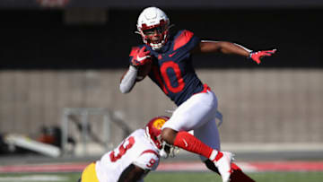 TUCSON, ARIZONA - NOVEMBER 14: Wide receiver Jamarye Joiner #10 of the Arizona Wildcats runs with the football past safety Greg Johnson #9 of the USC Trojans during the first half of the PAC-12 football game at Arizona Stadium on November 14, 2020 in Tucson, Arizona. (Photo by Christian Petersen/Getty Images)
