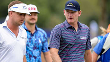 Apr 24, 2021; Avondale, Louisiana, USA; Brandt Snedeker talks to Keith Mitchell as they walk downtime 1st fairway on the practice green during the third round of the Zurich Classic of New Orleans golf tournament. Mandatory Credit: Stephen Lew-USA TODAY Sports