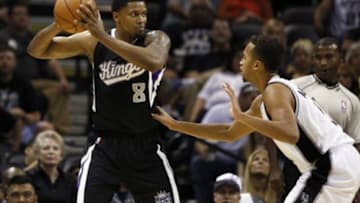 Oct 20, 2014; San Antonio, TX, USA; Sacramento Kings small forward Rudy Gay (8) is defended by San Antonio Spurs shooting guard Kyle Anderson (right) during the first half at AT&T Center. Mandatory Credit: Soobum Im-USA TODAY Sports
