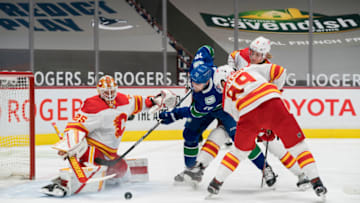 Feb 11, 2021; Vancouver, British Columbia, CAN; Calgary Flames defenseman Juuso Valimaki (6) and defenseman Nikita Nesterov (89) check Vancouver Canucks forward Tanner Pearson (70) as goalie Jacob Markstrom (25) makes a save in the first period at Rogers Arena. Mandatory Credit: Bob Frid-USA TODAY Sports