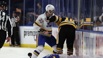 Mar 11, 2021; Buffalo, New York, USA; Pittsburgh Penguins center Zach Aston-Reese (12) gets into a fight with Buffalo Sabres defenseman Colin Miller (33) after he hits Buffalo Sabres center Dylan Cozens (24) during the third period at KeyBank Center. Mandatory Credit: Timothy T. Ludwig-USA TODAY Sports