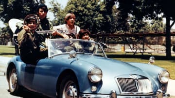 American pop group The Monkees performing in an MG sports car, circa 1967.