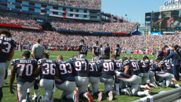 FOXBOROUGH, MA - SEPTEMBER 24: New England Patriots players take a knee during the national anthem before the start of a game against the Houston Texans at Gillette Stadium in Foxborough, Mass., Sept. 24, 2017. (Photo by Jim Davis/The Boston Globe via Getty Images)