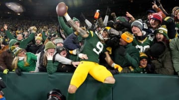 Green Bay Packers wide receiver Christian Watson (9) is embraced by fans on a Lambeau Leap after scoring a touchdown during the thirdt quarter of their game Sunday, November 13, 2022 at Lambeau Field in Green Bay, Wis. The Green Bay Packers beat the Dallas Cowboys 31-28 in overtime.Packers13 10