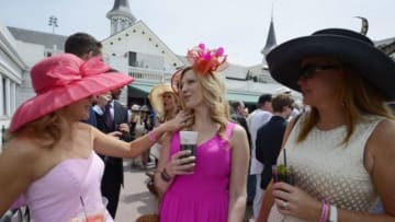 May 3, 2014; Louisville, KY, USA; Race fans Leanne Bryan (left) , Valerie Alexander (middle) and Kackie Billman on a balcony above the paddock area before the 2014 Kentucky Derby at Churchill Downs. Mandatory Credit: Jamie Rhodes-USA TODAY Sports