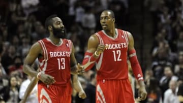 Nov 30, 2013; San Antonio, TX, USA; Houston Rockets guard James Harden (13) and forward Dwight Howard (12) react against the San Antonio Spurs during the second half at the AT&T Center. Houston beat San Antonio 112-106. Mandatory Credit: Brendan Maloney-USA TODAY Sports