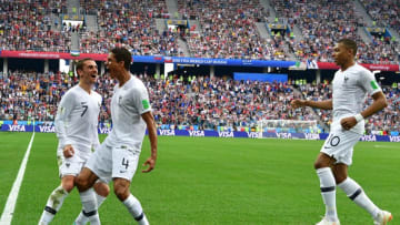 TOPSHOT - France's defender Raphael Varane (C) celebrates with France's forward Antoine Griezmann (L) and France's forward Kylian Mbappe after scoring the opener during the Russia 2018 World Cup quarter-final football match between Uruguay and France at the Nizhny Novgorod Stadium in Nizhny Novgorod on July 6, 2018. (Photo by Mladen ANTONOV / AFP) (Photo credit should read MLADEN ANTONOV/AFP/Getty Images)