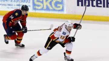 Apr 4, 2014; Sunrise, FL, USA; Calgary Flames left wing Mike Cammalleri (13) skates with the puck past Florida Panthers left wing Tomas Fleischmann (14) in the third period at BB&T Center. The Flames won 2-1. Mandatory Credit: Robert Mayer-USA TODAY Sports