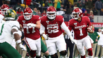 Dec 7, 2019; Arlington, TX, USA; Oklahoma Sooner quarterback Jalen Hurts (1) runs with the ball in the third quarter behind guard Tyresse Robinson (52) and tackle Erik Swenson (77) against the Baylor Bears in the 2019 Big 12 Championship Game at AT&T Stadium. Mandatory Credit: Matthew Emmons-USA TODAY Sports