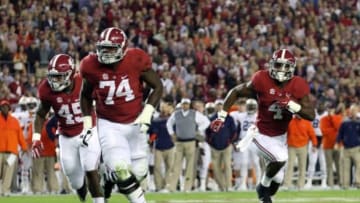 Nov 29, 2014; Tuscaloosa, AL, USA; Alabama Crimson Tide running back T.J. Yeldon (4) carries the ball for a touchdown in the first quarter against the Auburn Tigers at Bryant-Denny Stadium. Mandatory Credit: Marvin Gentry-USA TODAY Sports