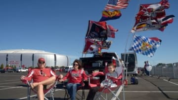 Nov 16, 2014; Glendale, AZ, USA; Arizona Cardinals fans Chuck Moretti (left), Irma Moretti (center) and Marissa Moretti of Scottsdale, AZ. tailgate before the game against the Detroit Lions at University of Phoenix Stadium. Mandatory Credit: Kirby Lee-USA TODAY Sports
