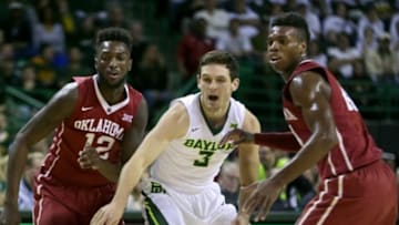 Jan 23, 2016; Waco, TX, USA; Baylor Bears guard Jake Lindsey (3) tries to pass between Oklahoma Sooners forward Khadeem Lattin (12) and guard Buddy Hield (24) at the Ferrell Center. Oklahoma won 82-72. Mandatory Credit: Erich Schlegel-USA TODAY Sports