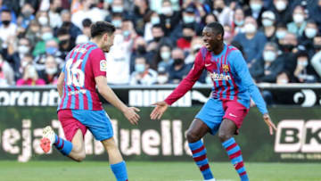 Pedri (L) celebrates with teammate Barcelona's French forward Ousmane Dembele (Photo by JOSE JORDAN / AFP) (Photo by JOSE JORDAN/AFP via Getty Images)