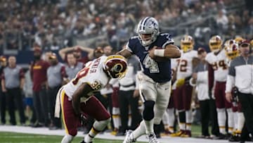 Nov 24, 2016; Arlington, TX, USA; Dallas Cowboys quarterback Dak Prescott (4) stiff arms Washington Redskins strong safety Donte Whitner Sr (39) during the second quarter at AT&T Stadium. Mandatory Credit: Jerome Miron-USA TODAY Sports