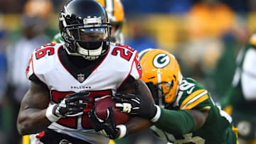 GREEN BAY, WISCONSIN - DECEMBER 09: Tevin Coleman #26 of the Atlanta Falcons runs against Tony Brown #28 of the Green Bay Packers during the second half of a game at Lambeau Field on December 09, 2018 in Green Bay, Wisconsin. (Photo by Stacy Revere/Getty Images)
