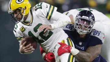 Nov 17, 2022; Green Bay, Wisconsin, USA; Green Bay Packers quarterback Aaron Rodgers (12) is sacked by Tennessee Titans defensive tackle Jeffery Simmons (98) in the fourth quarter at Lambeau Field. Mandatory Credit: Dan Powers-USA TODAY Sports