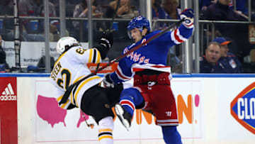 NEW YORK, NEW YORK - SEPTEMBER 28: Jacob Trouba #8 of the New York Rangers checks Oskar Steen #62 of the Boston Bruins in a preseason game at Madison Square Garden on September 28, 2021 in New York City. (Photo by Bruce Bennett/Getty Images)