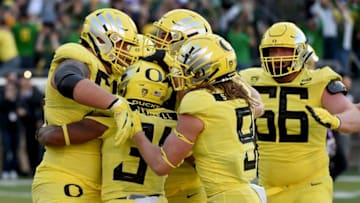 EUGENE, OR - OCTOBER 13: Running back CJ Verdell #34 of the Oregon Ducks celebrates with teammates after scoring the winning touchdown in overtime of the game against the Washington Huskies at Autzen Stadium on October 13, 2018 in Eugene, Oregon. The Ducks won the game 30-27. (Photo by Steve Dykes/Getty Images)