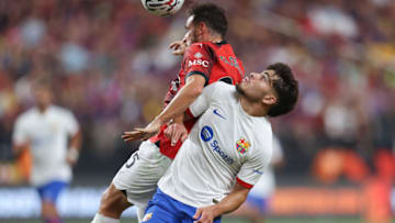 LAS VEGAS, NEVADA - AUGUST 1: Alessandro Florenzi #25 of AC Milan goes for a header against Abde Ezzalzouli #16 of Barcelona during the pre-season friendly match at Allegiant Stadium on August 1, 2023 in Las Vegas, Nevada. (Photo by Omar Vega/Getty Images)