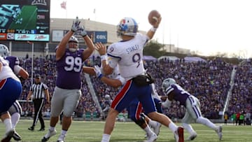 Nov 26, 2016; Manhattan, KS, USA; Kansas State Wildcats defensive tackle Trey Dishon (99) tries to knock down a pass by Kansas Jayhawks quarterback Carter Stanley (9) during a game at Bill Snyder Family Football Stadium. The Wildcats won the game, 34-19. Mandatory Credit: Scott Sewell-USA TODAY Sports
