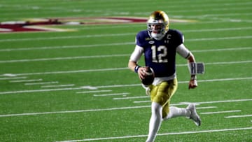 CHESTNUT HILL, MASSACHUSETTS - NOVEMBER 14: Ian Book #12 of the Notre Dame Fighting Irish runs the ball in for a touchdown against the Boston College Eagles during the second half at Alumni Stadium on November 14, 2020 in Chestnut Hill, Massachusetts. (Photo by Maddie Meyer/Getty Images)